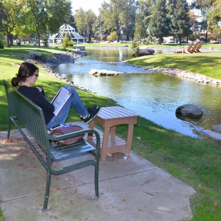 California State University, Stanislaus, or Stanislaus State, student studying at the lake and meditation pond