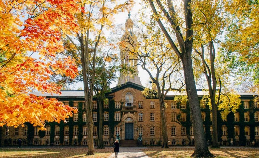 college campus building surrounded by fall foliage