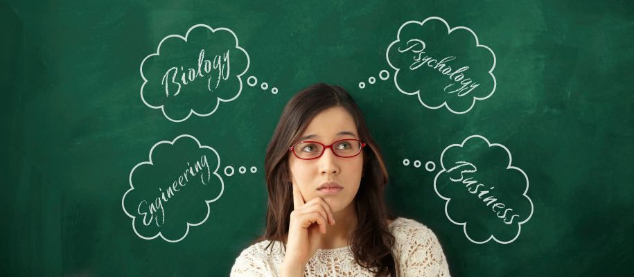 woman in glasses in front of chalkboard
