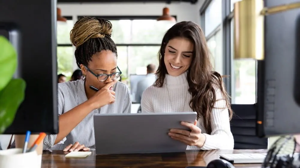 two women looking at computer